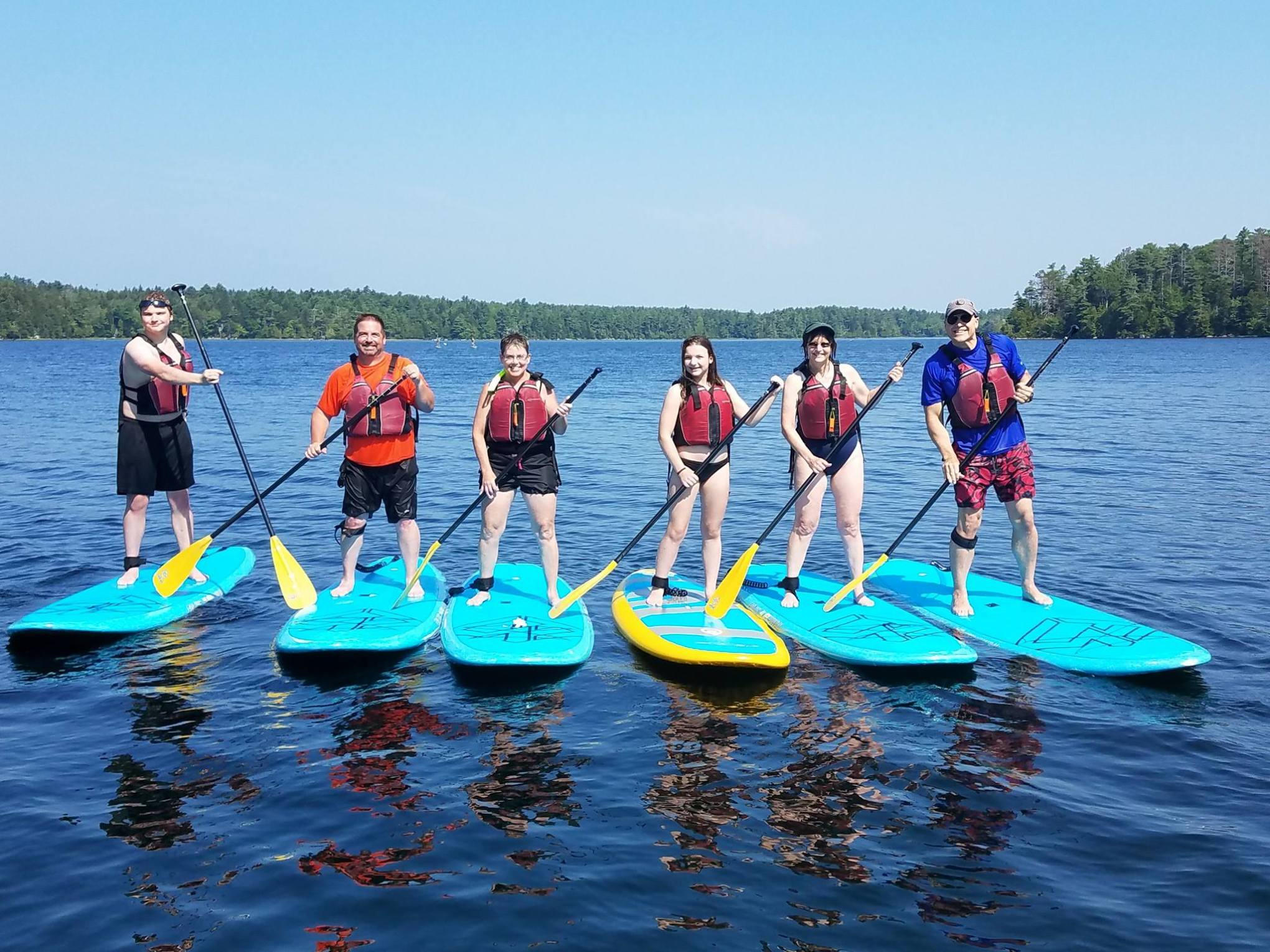 family doing stand up paddleboard